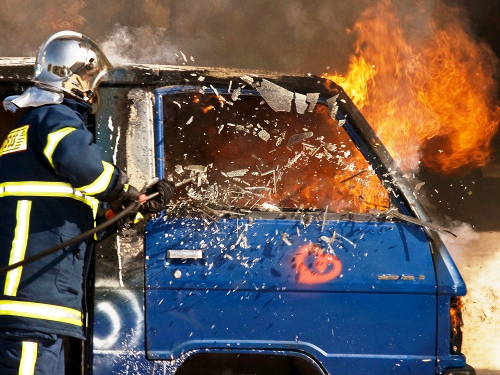 Firefighter smashing car window